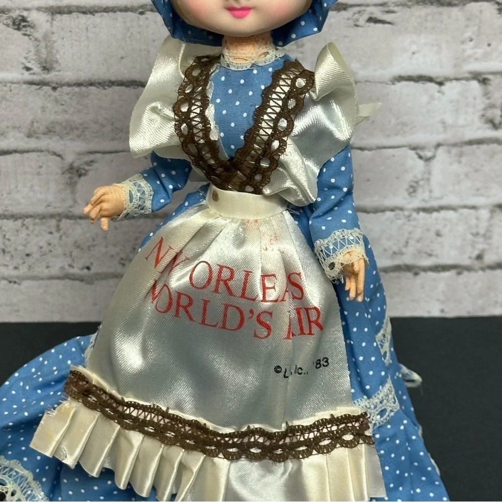 Vintage 1983 New Orleans World's Fair Big Eyes Doll Dress Bonnet Stand 10 in.